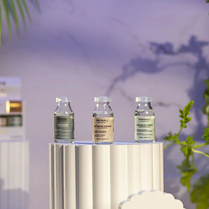 Three skincare bottles on a stand with a blurred indoor background