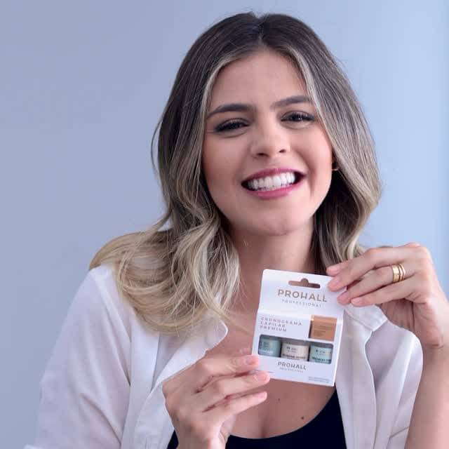 Woman holding a color swatch card against a light gray background