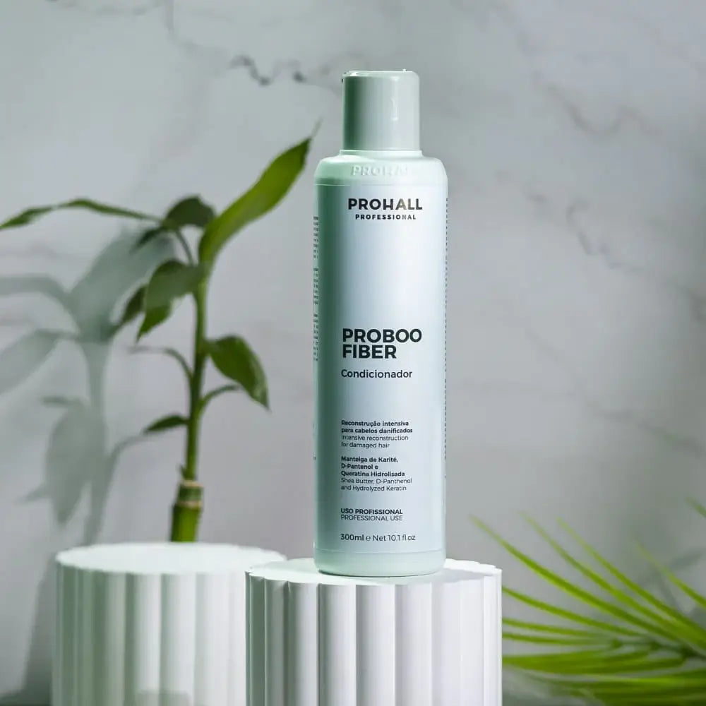 Prohall Proboo Fiber bottle on a white cylindrical stand with a plant in the background
