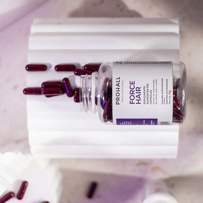 Bottle of Prohall Force Hair supplement with capsules on a light background