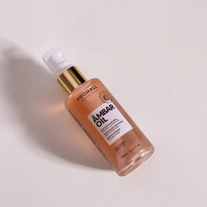 Ambar Oil bottle with gold cap on a light background