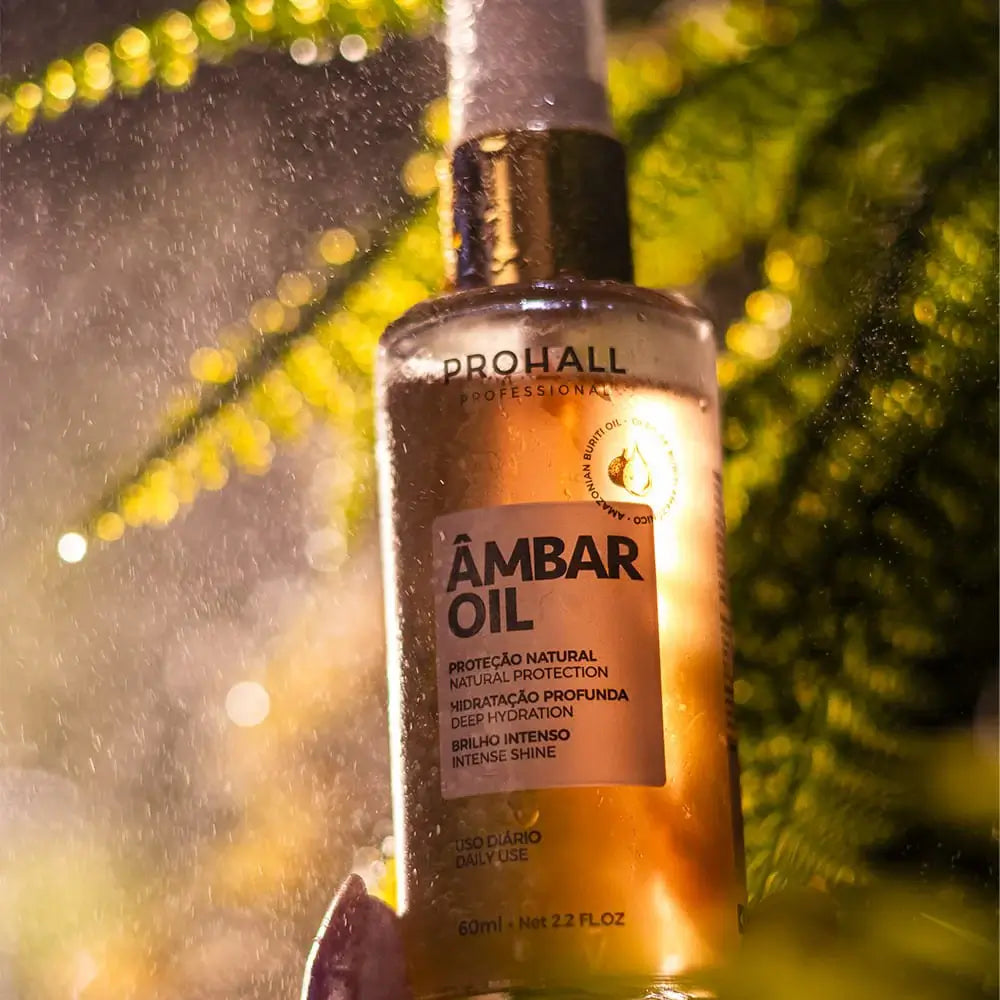 Bottle of Prohall Ambar Oil with a blurred green leaf background