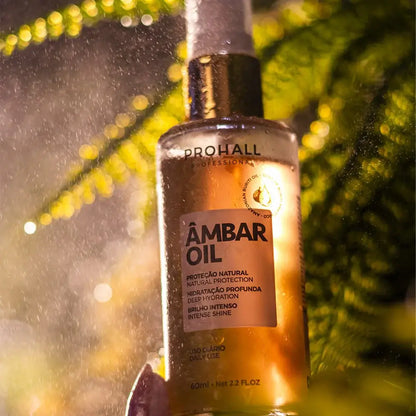 Bottle of Prohall Ambar Oil with a blurred green leaf background