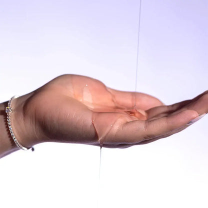 Hand wearing a transparent glove on a white background