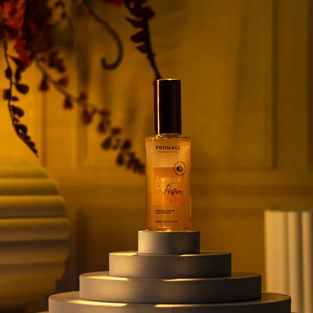 Amber glass perfume bottle on a pedestal with a blurred background