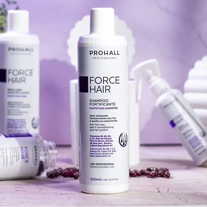 Prohall Force Hair shampoo bottle on a blurred background with other skincare products.