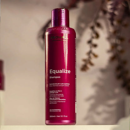 Shampoo Equalize bottle in a warm decorated background with brown leaves behind