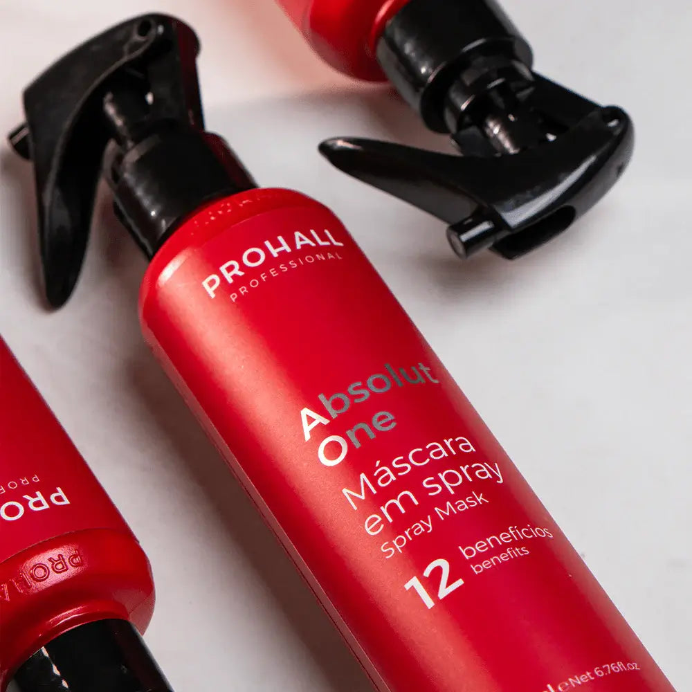 Red spray bottle with black nozzle labeled 'Prohall' on a light gray background