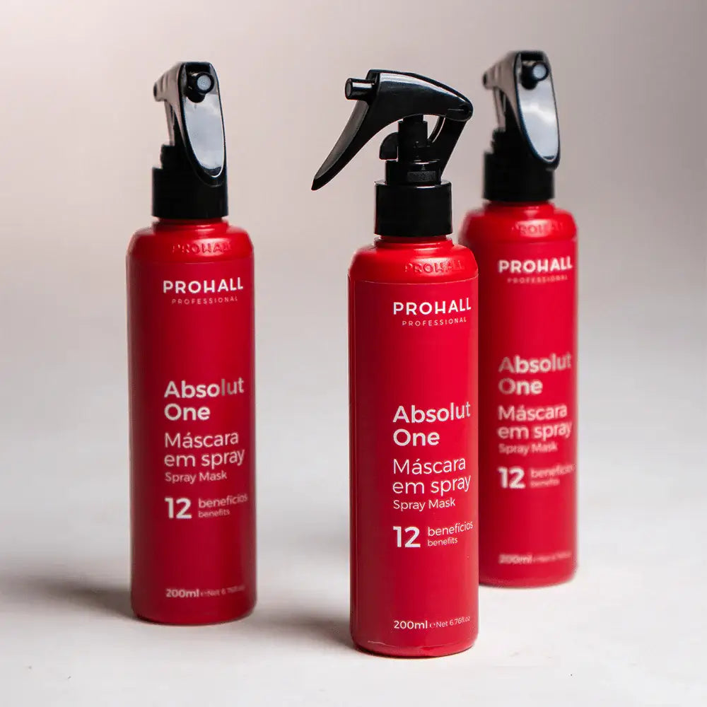 Three red bottles of Prohall Absolut One Spray Mask on a light background