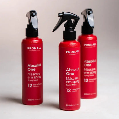 Three red bottles of Prohall Absolut One Spray Mask on a light background